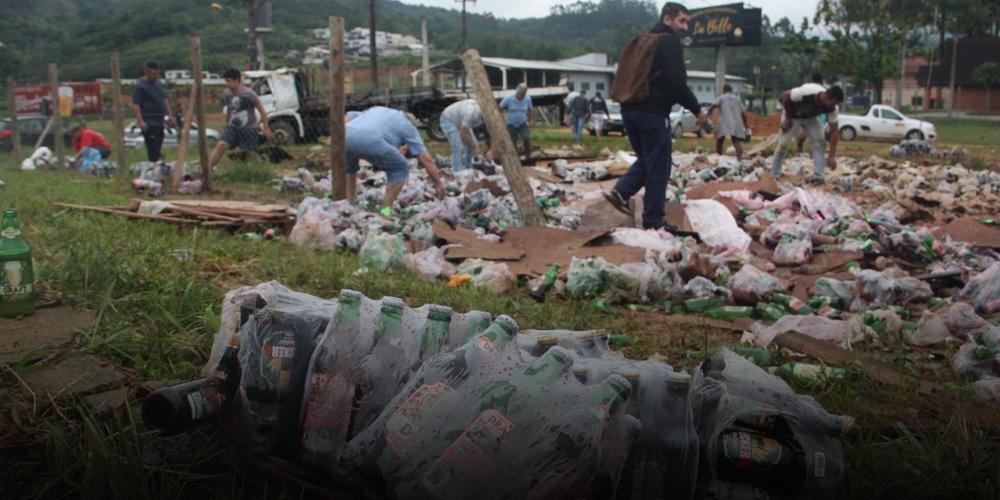 Caminhão tomba e carga de cerveja e outras bebidas é saqueada